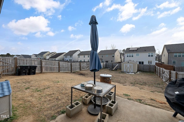 view of yard with a storage unit and a patio