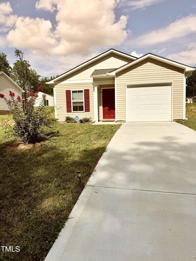 view of front of property featuring a garage and a front yard