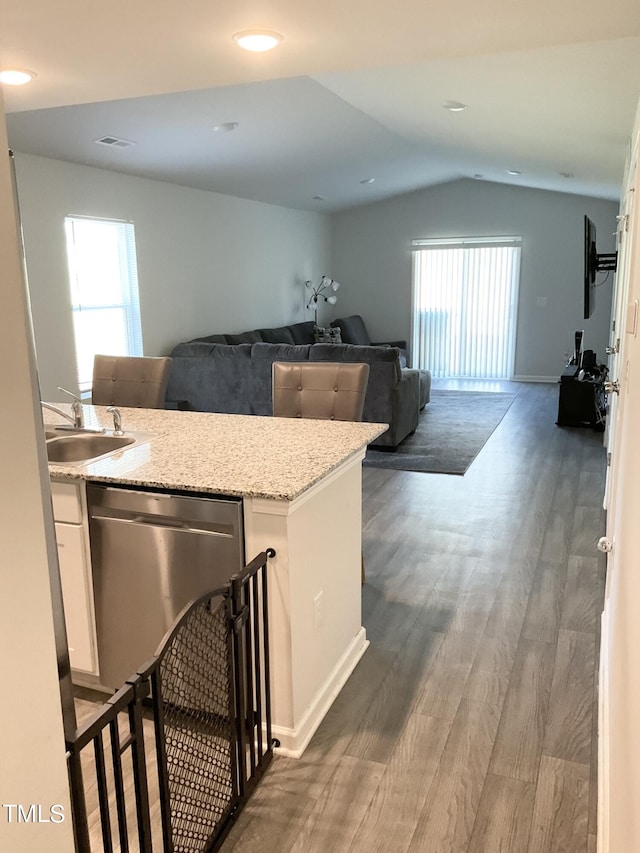 kitchen with plenty of natural light, dark hardwood / wood-style flooring, lofted ceiling, white cabinets, and sink