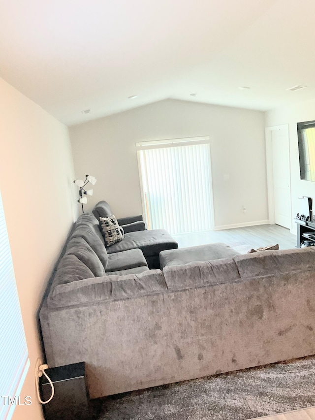 living room with vaulted ceiling and hardwood / wood-style flooring