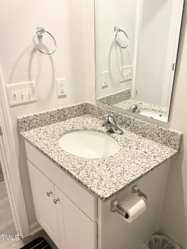 bathroom featuring hardwood / wood-style floors and vanity