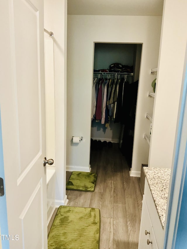 bathroom with vanity, a tub, and hardwood / wood-style flooring