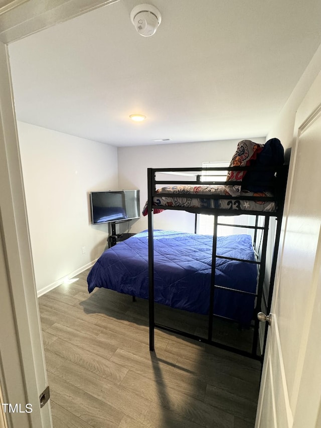 bedroom with hardwood / wood-style flooring