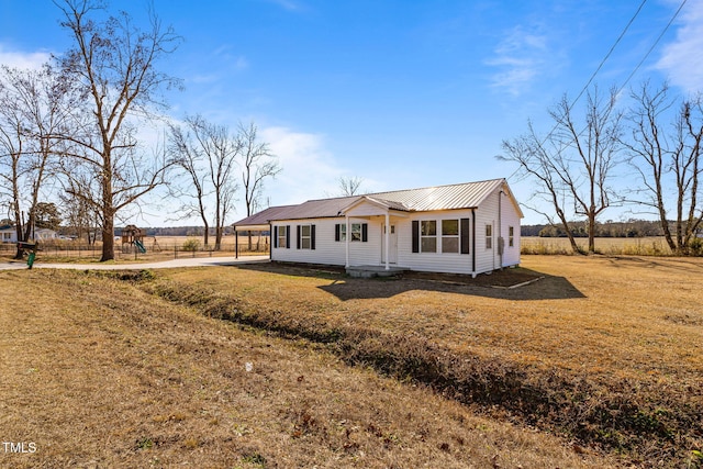 view of front of house featuring a front yard and a rural view