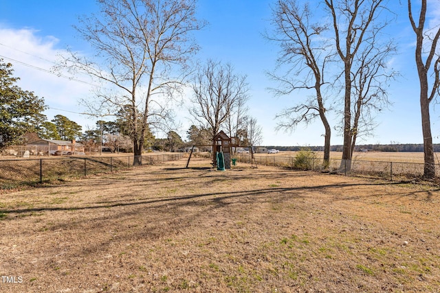 view of yard with a playground and a rural view