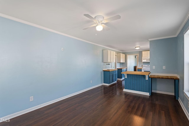 kitchen with butcher block countertops, dark hardwood / wood-style floors, electric range, crown molding, and a breakfast bar