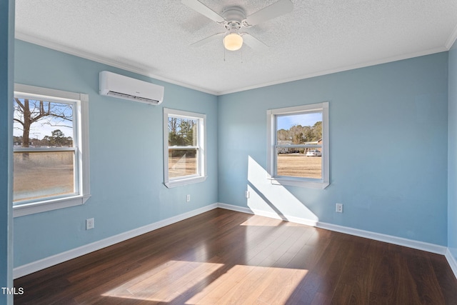 spare room featuring a textured ceiling, dark hardwood / wood-style floors, ornamental molding, and a wall unit AC