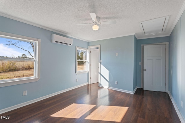 interior space with a textured ceiling, dark hardwood / wood-style floors, ornamental molding, and a wall unit AC