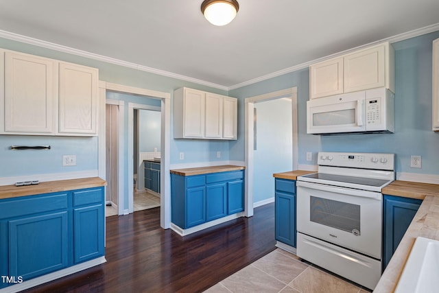 kitchen with white cabinetry, blue cabinetry, white appliances, crown molding, and dark tile patterned floors