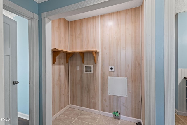 laundry room with light tile patterned floors, hookup for an electric dryer, wood walls, and hookup for a washing machine