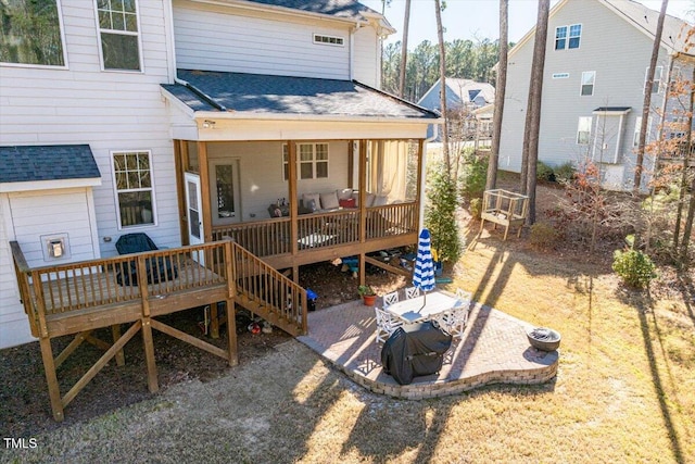 back of property featuring a deck, a patio, stairway, and roof with shingles