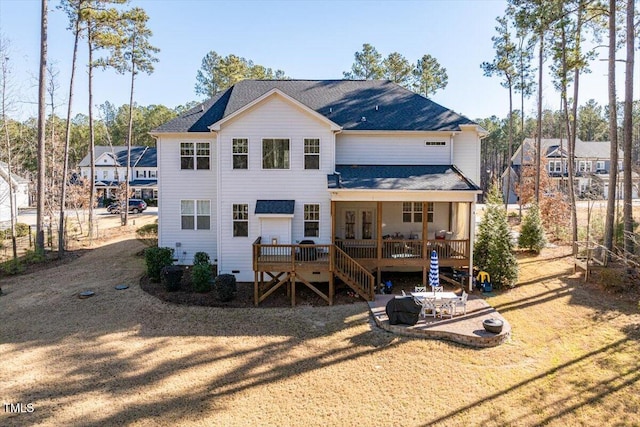 rear view of property featuring a fire pit, stairway, a patio area, and a wooden deck