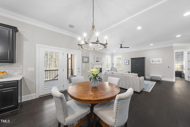 dining room featuring dark wood-style flooring, crown molding, and baseboards