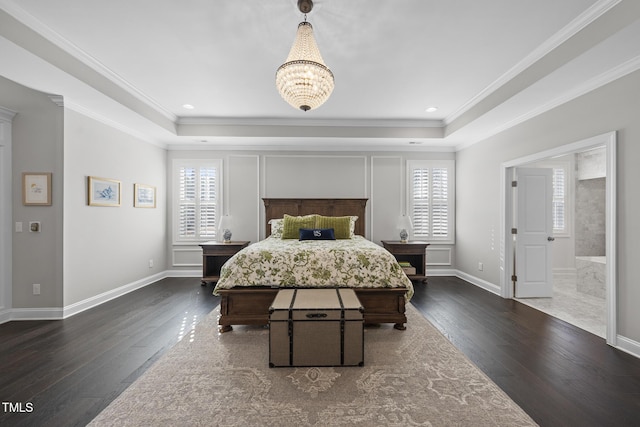 bedroom featuring a tray ceiling, wood-type flooring, and crown molding