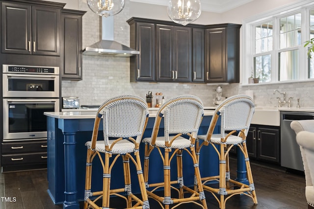 kitchen with decorative backsplash, wall chimney exhaust hood, dark wood-type flooring, stainless steel appliances, and crown molding