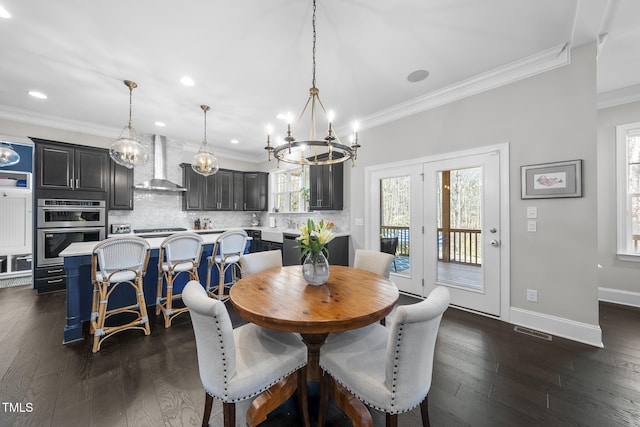 dining space with ornamental molding, dark wood finished floors, visible vents, and baseboards