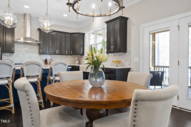 dining area featuring dark wood-type flooring, recessed lighting, a chandelier, and crown molding