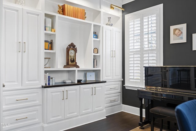 living area featuring dark wood-type flooring and baseboards