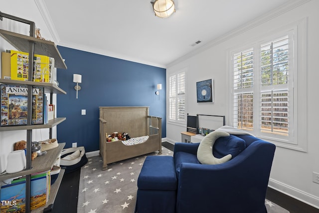 living room with baseboards, visible vents, and crown molding