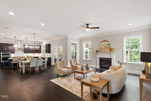 1141 Barley Stone Way, Raleigh, NC 27603 - living area with a glass covered fireplace, dark wood-type flooring, ceiling fan, a chandelier, and recessed lighting