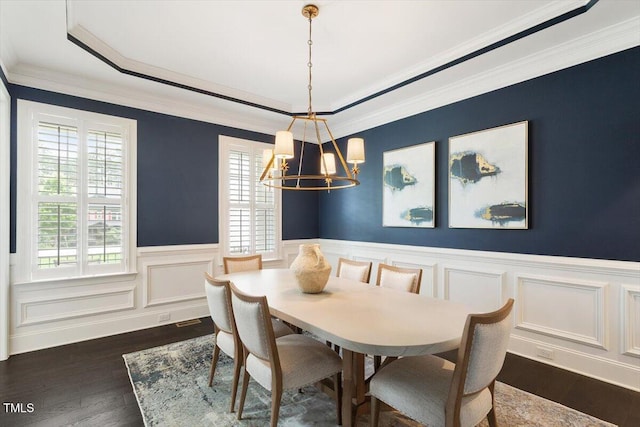 1141 Barley Stone Way, Raleigh, NC 27603 - dining room featuring a chandelier, a wainscoted wall, dark wood finished floors, ornamental molding, and a raised ceiling