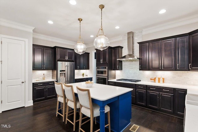 1141 Barley Stone Way, Raleigh, NC 27603 - kitchen with wall chimney exhaust hood, stainless steel appliances, a kitchen island, a breakfast bar area, and light countertops