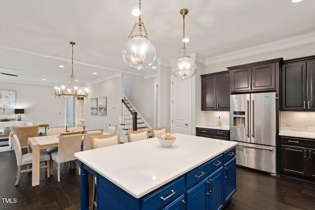 1141 Barley Stone Way, Raleigh, NC 27603 - kitchen with high end fridge, a chandelier, light countertops, dark wood-type flooring, and tasteful backsplash