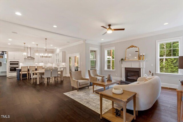 1141 Barley Stone Way, Raleigh, NC 27603 - living area with a glass covered fireplace, a ceiling fan, plenty of natural light, dark wood-type flooring, and ornamental molding