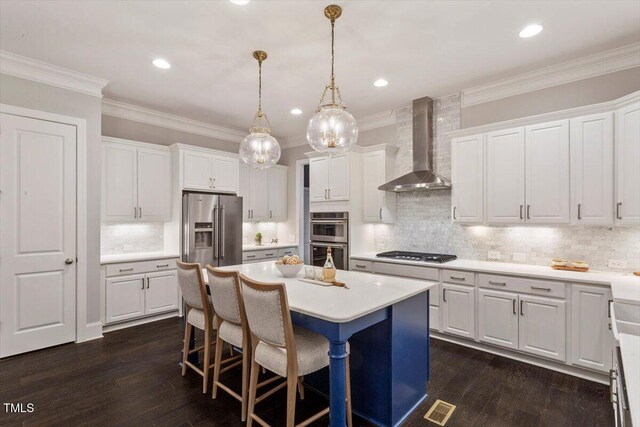 1141 Barley Stone Way, Raleigh, NC 27603 - kitchen with wall chimney range hood, stainless steel appliances, a center island, white cabinets, and crown molding