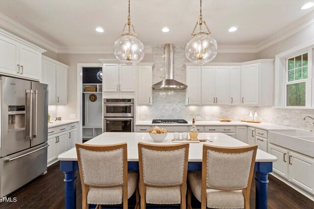 1141 Barley Stone Way, Raleigh, NC 27603 - kitchen with stainless steel appliances, wall chimney range hood, tasteful backsplash, a center island, and ornamental molding