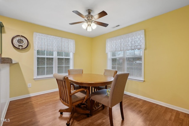 dining space featuring light hardwood / wood-style floors and ceiling fan