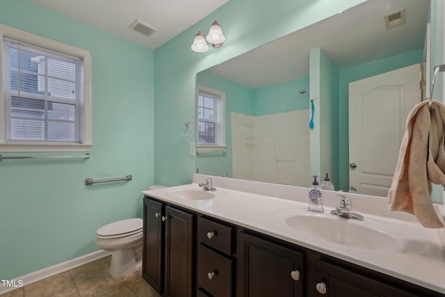 bathroom with vanity, tile patterned floors, and toilet