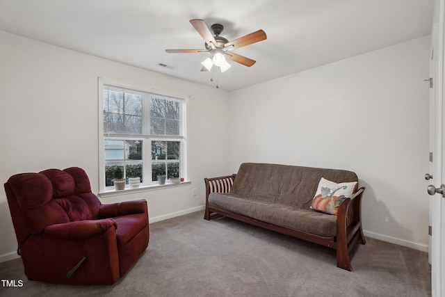 living room featuring ceiling fan and carpet