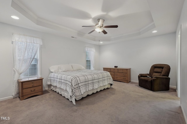 bedroom with a raised ceiling, ornamental molding, light carpet, and ceiling fan