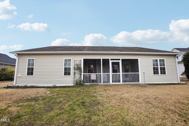 back of property featuring a lawn