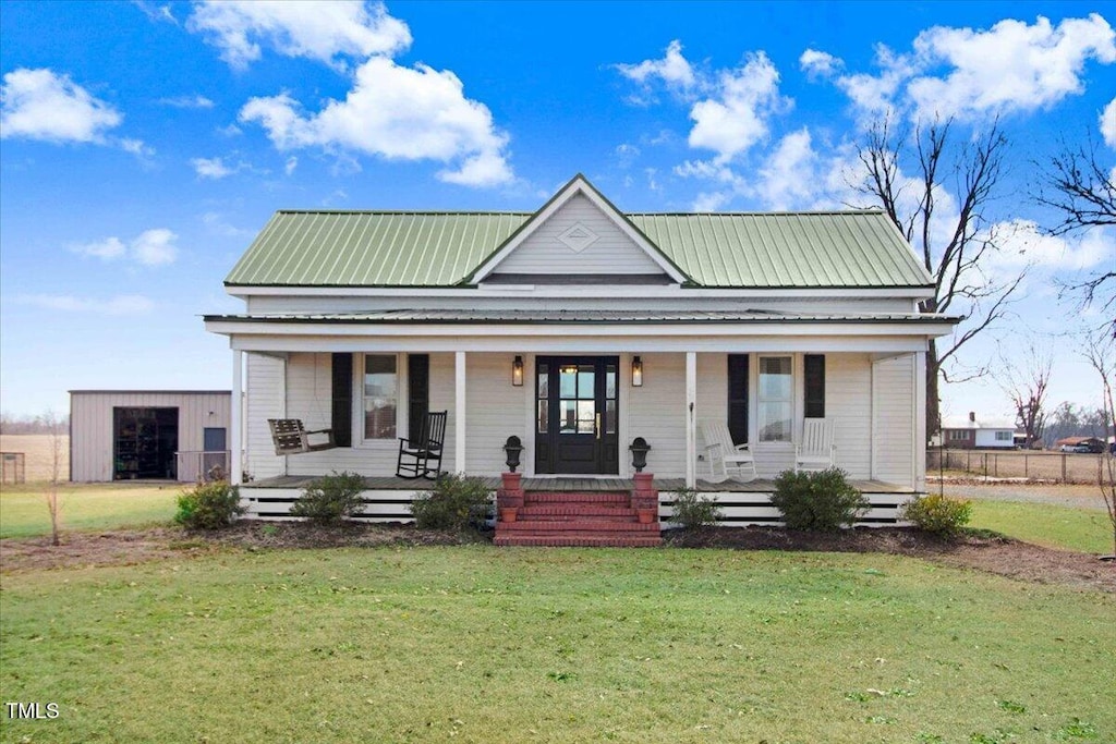 view of front of property with a front yard and covered porch