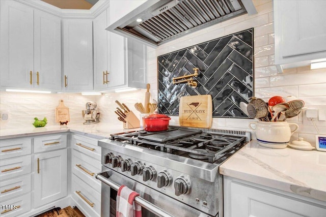 kitchen with white cabinetry, backsplash, stainless steel stove, and custom exhaust hood