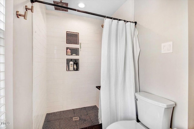 bathroom with toilet and curtained shower