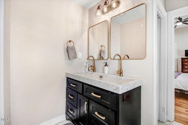 bathroom with ceiling fan and vanity