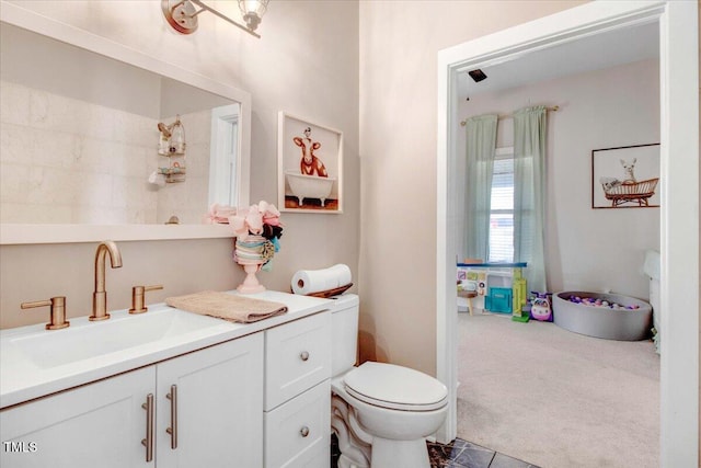 bathroom with toilet and vanity