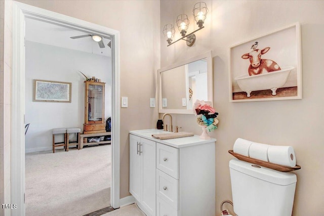 bathroom with toilet, ceiling fan, and vanity