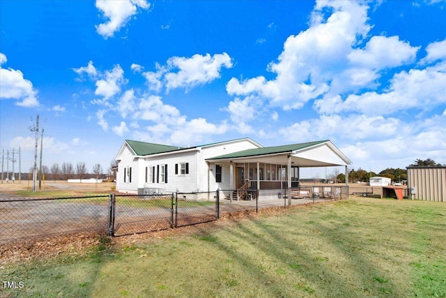 rear view of house featuring a lawn