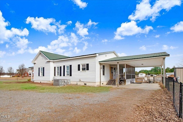 manufactured / mobile home featuring central AC, a patio area, and a sunroom