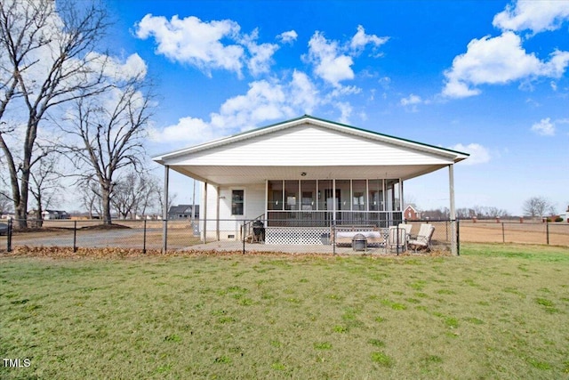 view of front of home with a front yard and a sunroom