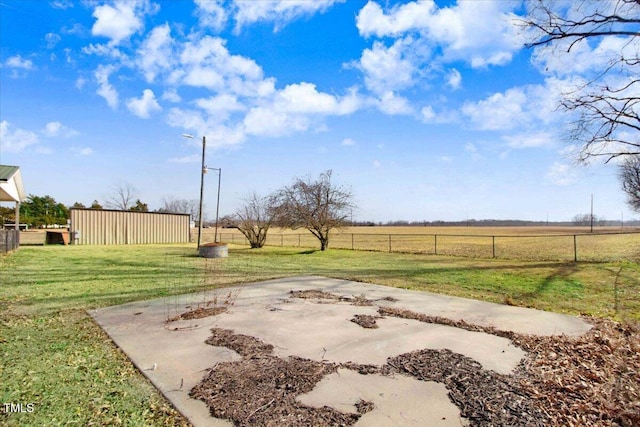 view of yard with a rural view and a patio