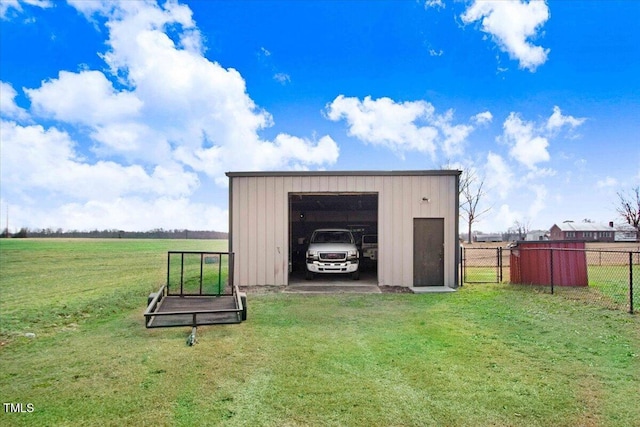 view of outbuilding featuring a rural view and a lawn