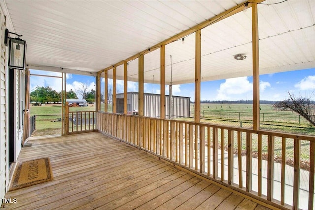 unfurnished sunroom with a rural view