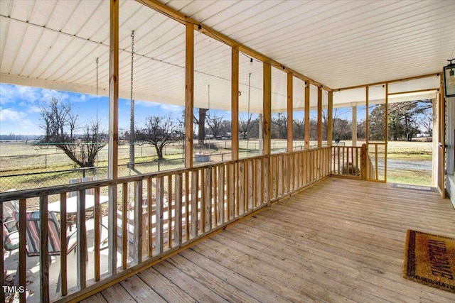 unfurnished sunroom with a rural view