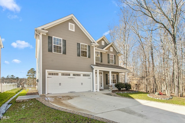 view of property featuring covered porch and a garage