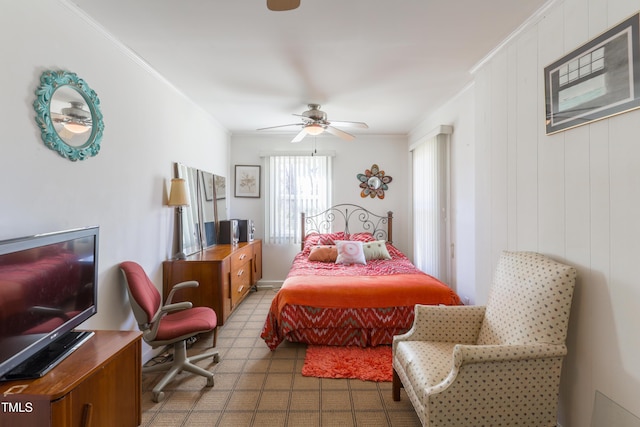 bedroom with ceiling fan, crown molding, and wood walls